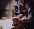 man working on a worktable with a woodworking plane