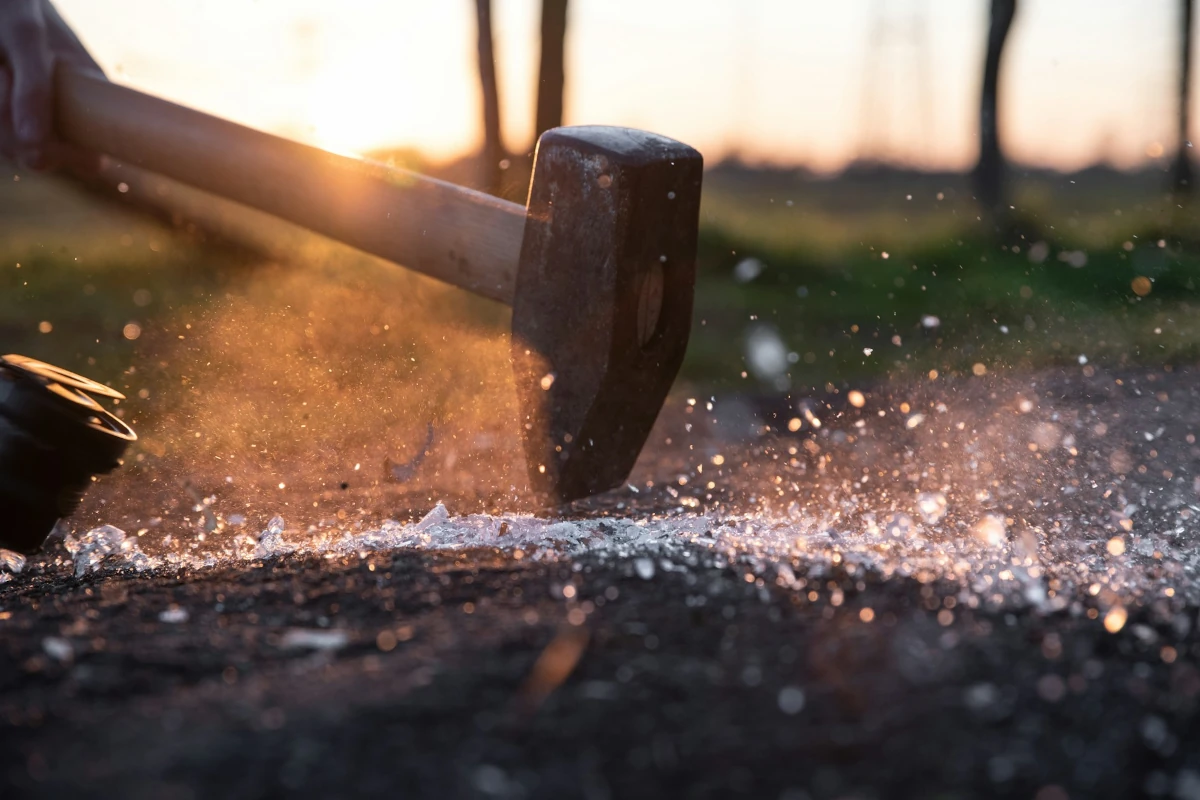 picture of a hammer hitting a glass