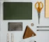 Household items (scissors, paper clips, pencils, coins) laying on the white background