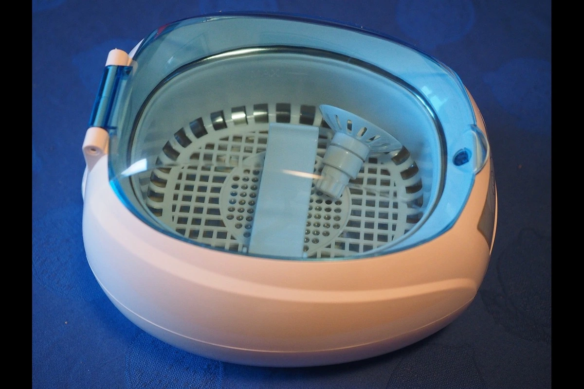 An ultrasonic cleaner tool on the blue surface