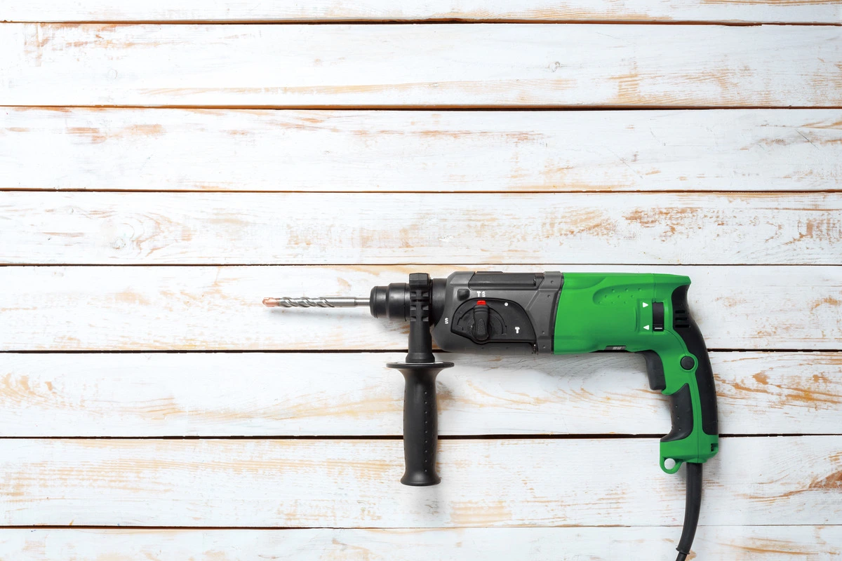 Rotary hammer on a wooden background