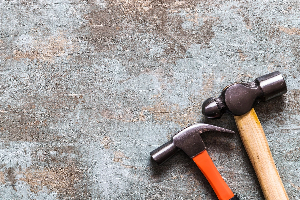 high-angle-view-two-hammers-old-wooden-desk