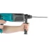 A person holding a hammer drill in the hand on white background